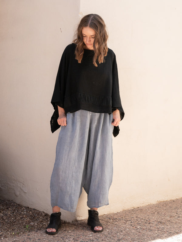 Conscious Coterie Tori Linen Top in Black on model looking down full front view