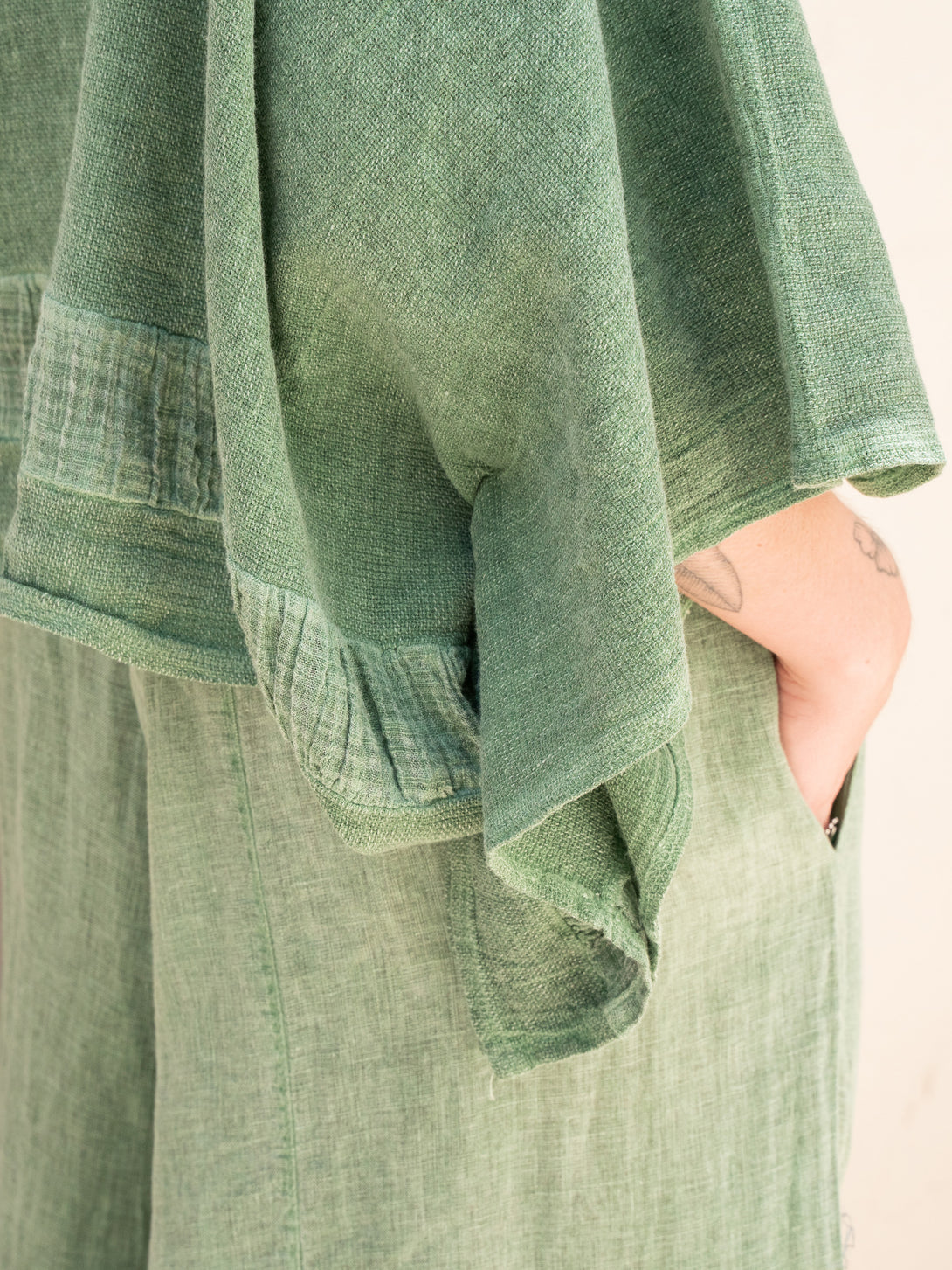 Conscious Coterie Tori Linen Top in Forest Green on model sleeve detail view