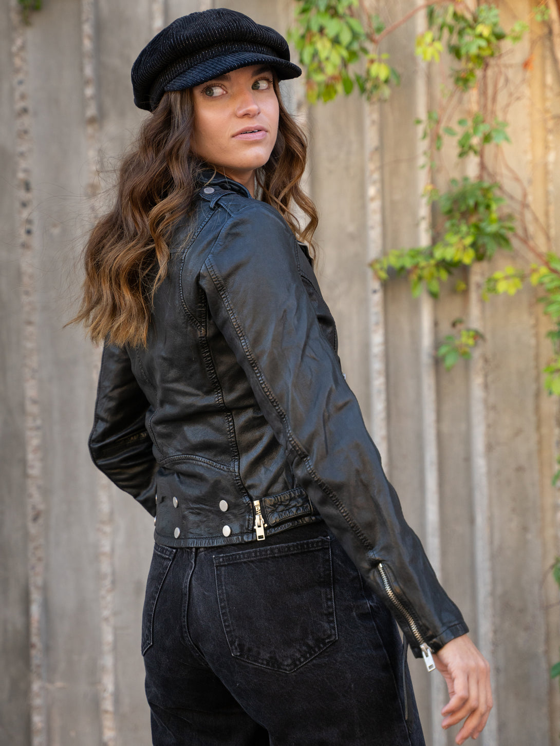 Conscious Coterie Wild Leather Jacket in black on model looking over shoulder editorial image