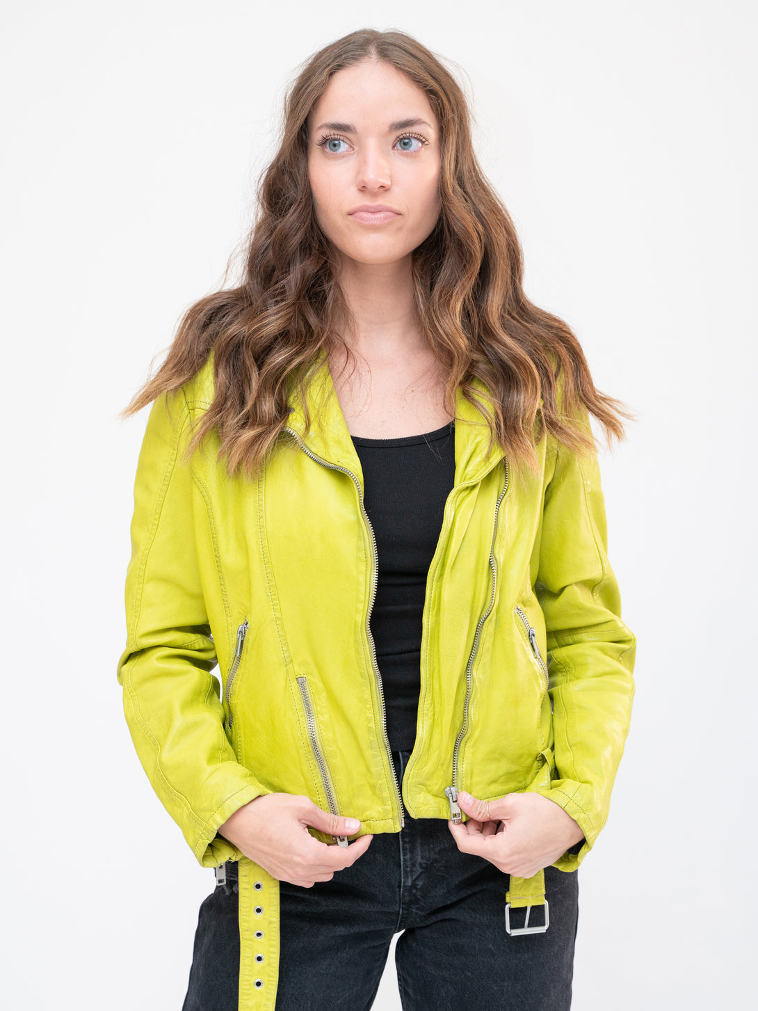 Conscious Coterie Wild Leather Jacket in lime on model holding zipper front view