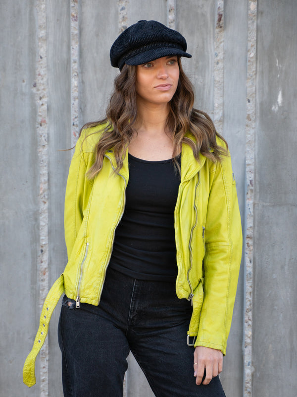 Conscious Coterie Wild Leather Jacket in lime on model with hat on editorial image