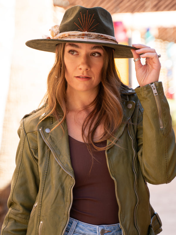 Conscious Coterie Wild Leather Jacket in olive on model wearing hat editorial image front view