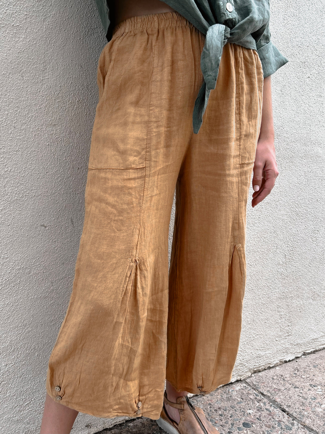 Conscious Coterie Yoli Pant in Camel on model front bottom detail view