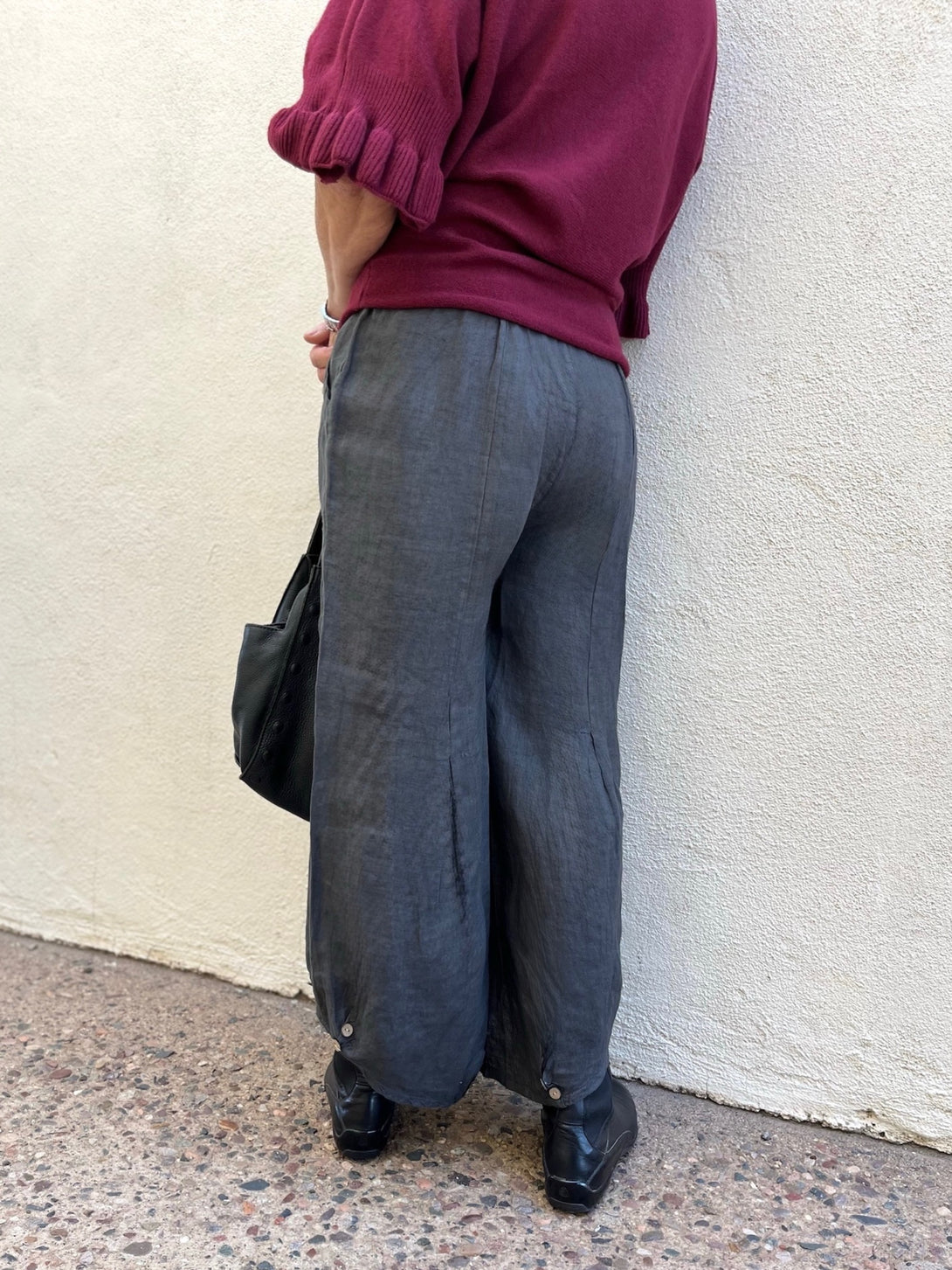 Conscious Coterie Yoli Pant in Charcoal back view of the pants on a woman