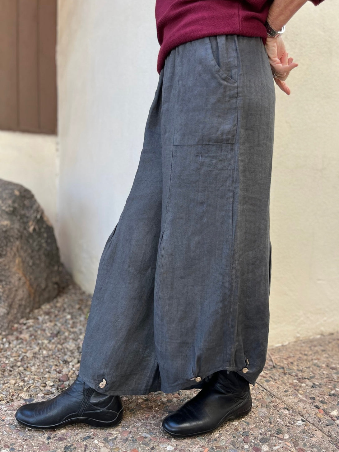 Conscious Coterie Yoli Pant in Charcoal side view of pants on woman taking a step