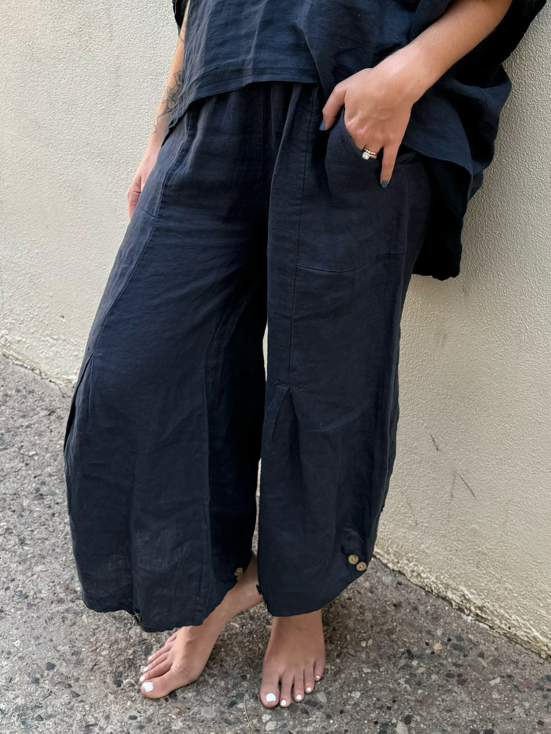 Conscious Coterie Yoli Pant in Navy on model front bottom detail view