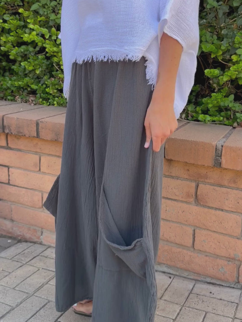 Conscious Coterie Lucy Pant in charcoal gray video of woman wearing pants showing the big pockets and wide leg detail