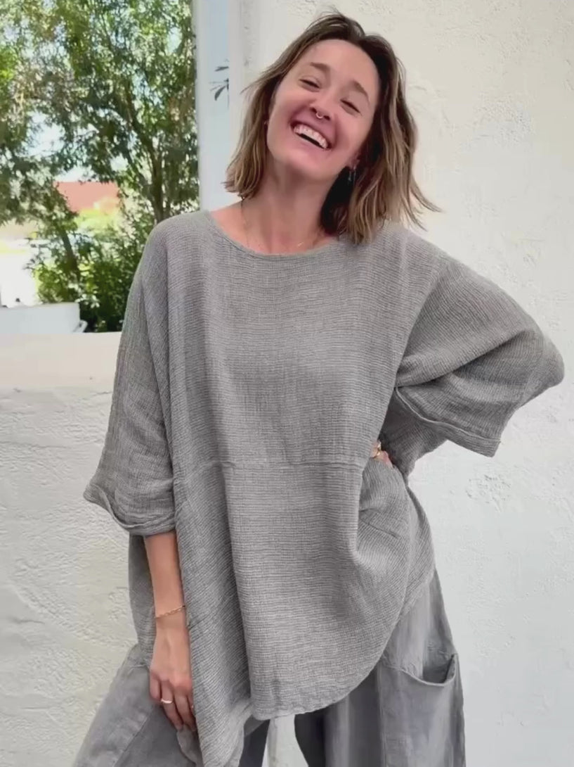 Conscious Coterie Lara top in charcoal video of woman wearing top showing it close up and as she moves around in it